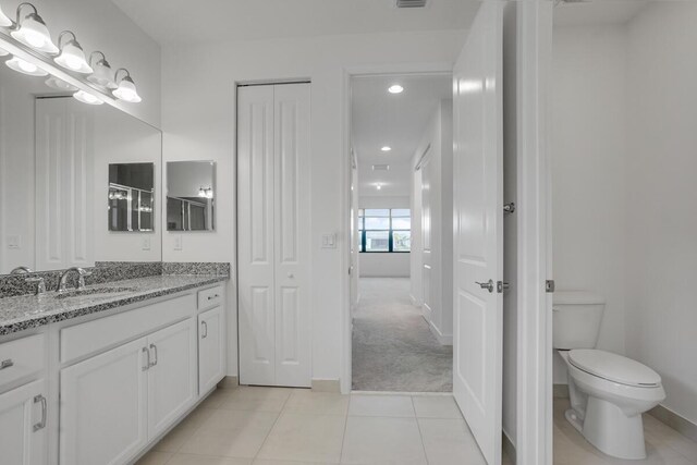 bathroom featuring tile patterned flooring, vanity, and a shower with door