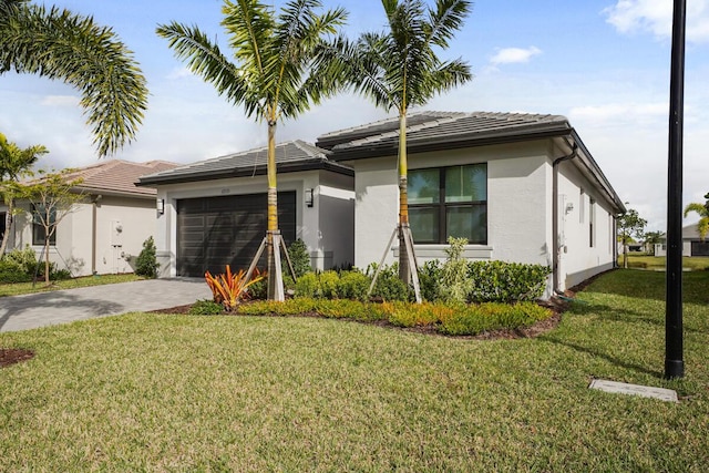 view of front of house with a garage and a front lawn