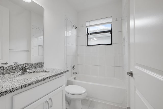 full bathroom with tile patterned flooring, tiled shower / bath combo, toilet, and vanity