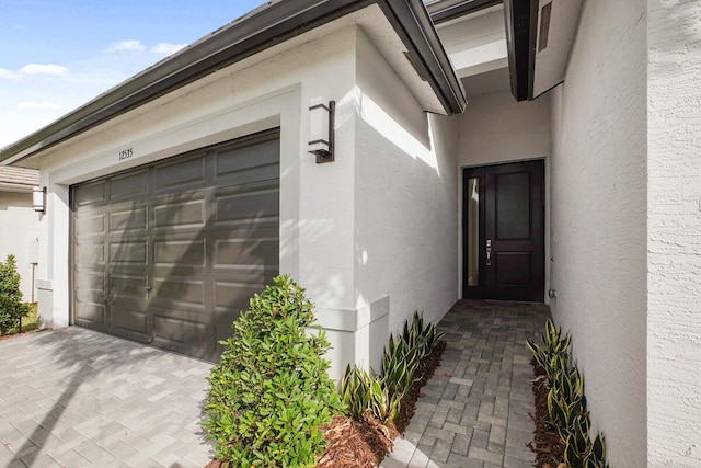 12535 SW Blue Mangrove Pkwy, Port Saint Lucie, FL 34987 - property entrance featuring stucco siding and an attached garage