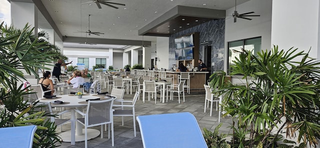 view of patio / terrace featuring ceiling fan and a bar