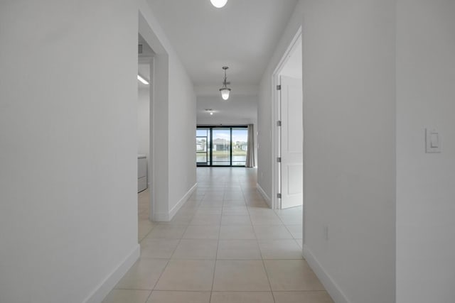 hall with light tile patterned floors