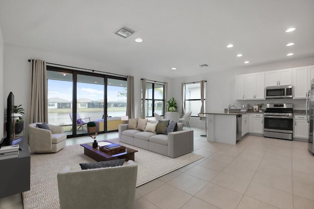 12535 SW Blue Mangrove Pkwy, Port Saint Lucie, FL 34987 - living room featuring recessed lighting, light tile patterned floors, and a water view