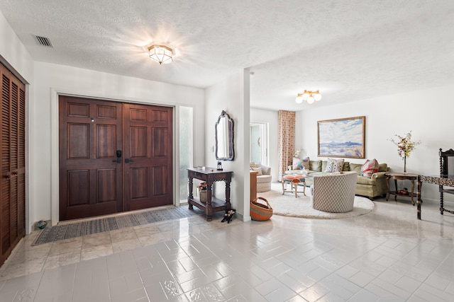 entryway with a textured ceiling