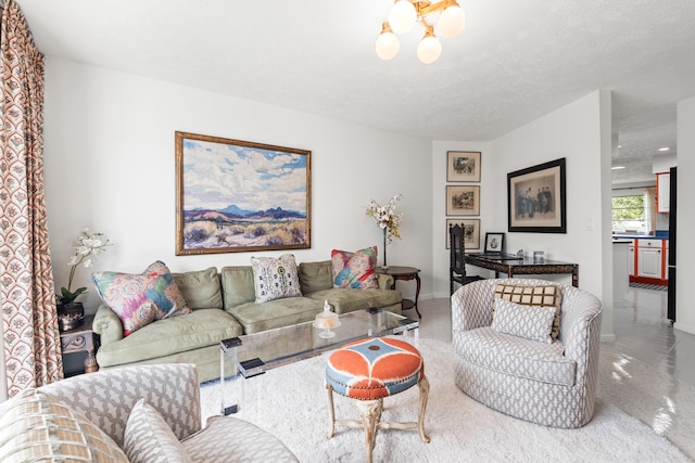 living room with a textured ceiling and an inviting chandelier