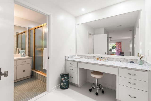 bathroom featuring ceiling fan, vanity, and walk in shower