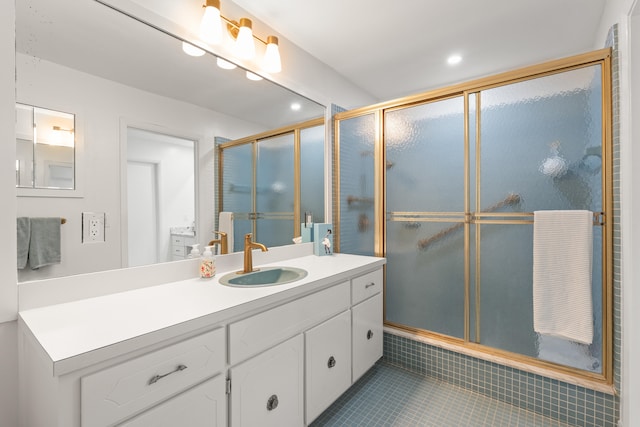 bathroom with tile patterned floors, vanity, and walk in shower