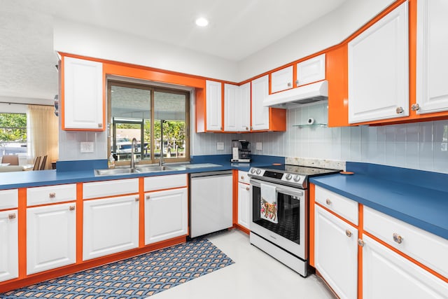 kitchen featuring backsplash, sink, white cabinets, and appliances with stainless steel finishes