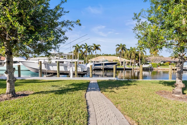 dock area with a lawn and a water view