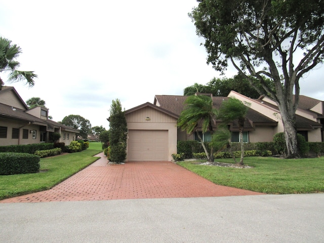 ranch-style home with a front lawn and a garage