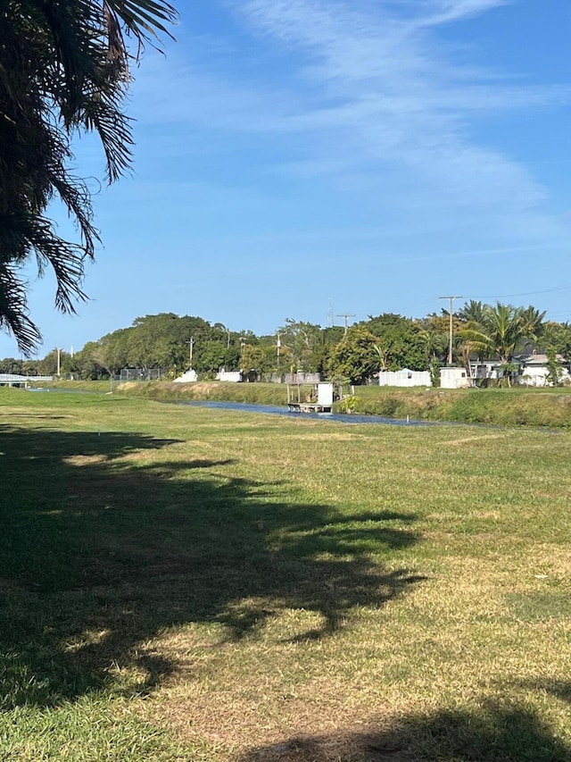 view of home's community featuring a lawn