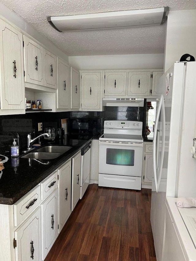 kitchen featuring white cabinetry, dark hardwood / wood-style flooring, white appliances, and sink