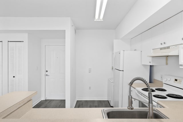 kitchen with dark hardwood / wood-style flooring, white cabinetry, sink, and white appliances