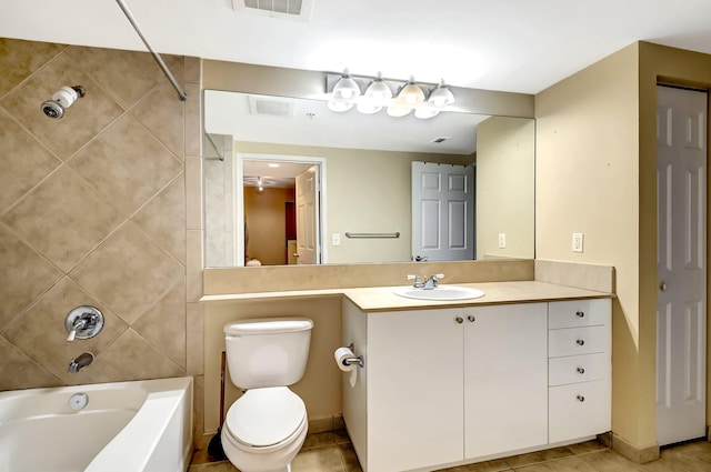 full bathroom featuring tile patterned floors, toilet, vanity, and tiled shower / bath