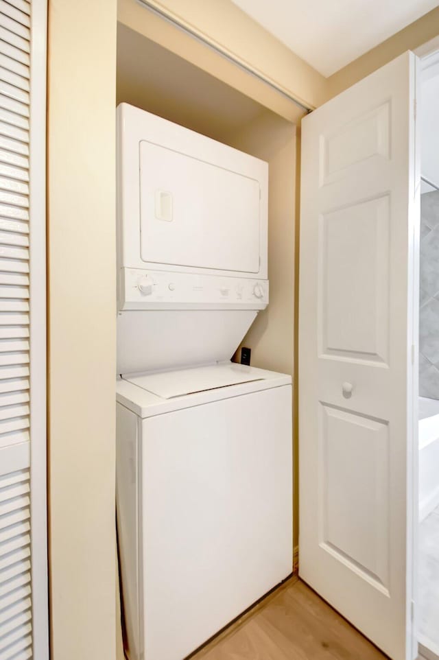 700 E Boynton Beach Blvd Unit 407, Boynton Beach, FL 33435 - laundry area with stacked washing machine and dryer and light wood-style floors