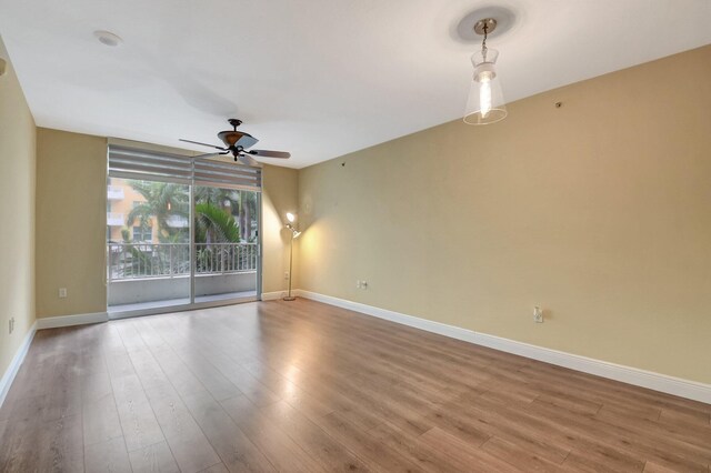 unfurnished living room featuring ceiling fan and light wood-type flooring