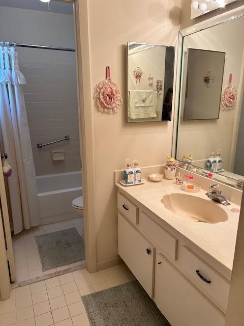 full bathroom with tile patterned floors, shower / tub combo with curtain, vanity, and toilet