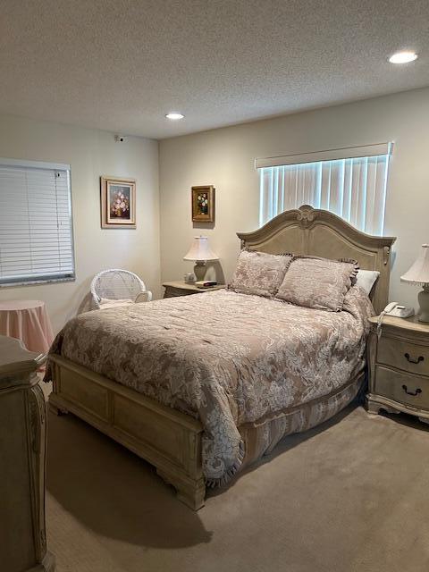 carpeted bedroom with a textured ceiling