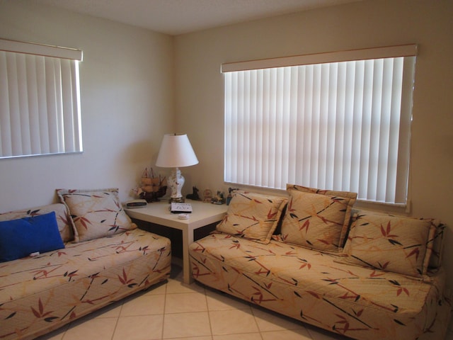 unfurnished living room with light tile patterned floors and a wealth of natural light