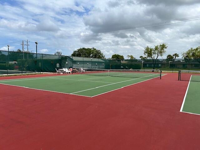 view of tennis court with basketball hoop