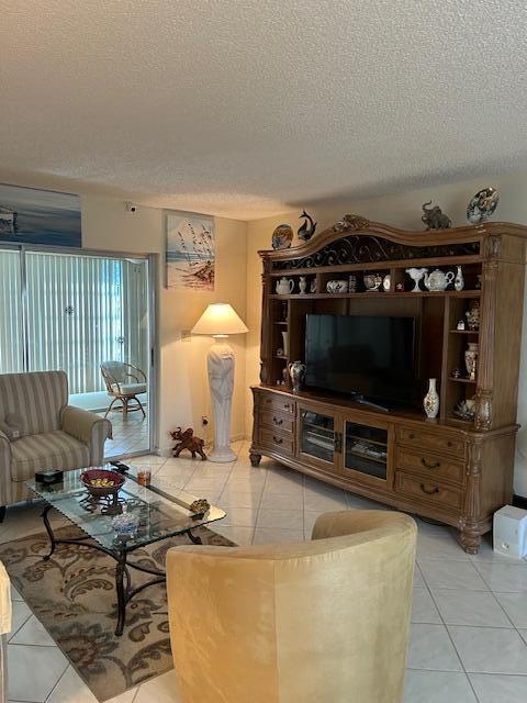 tiled living room with a textured ceiling