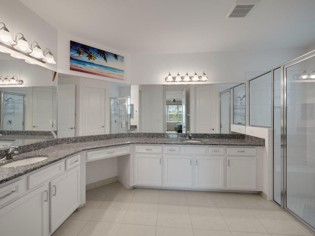 bathroom featuring tile patterned floors, vanity, and an enclosed shower