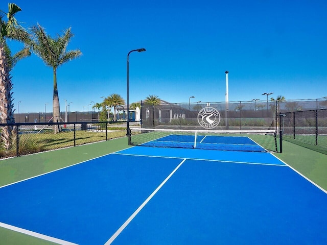 view of tennis court featuring basketball court