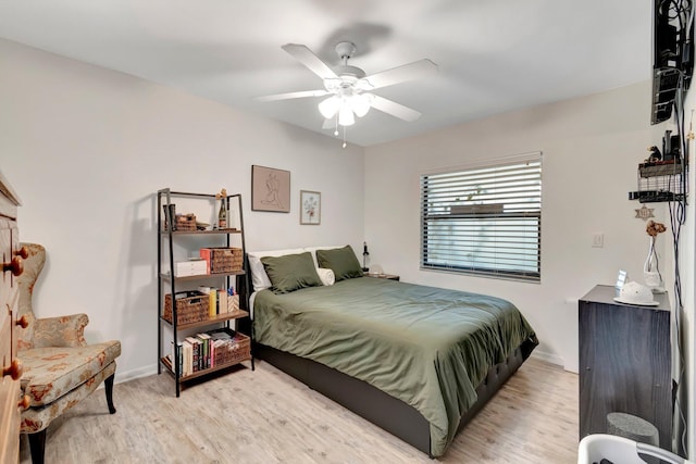 bedroom with ceiling fan and light hardwood / wood-style flooring