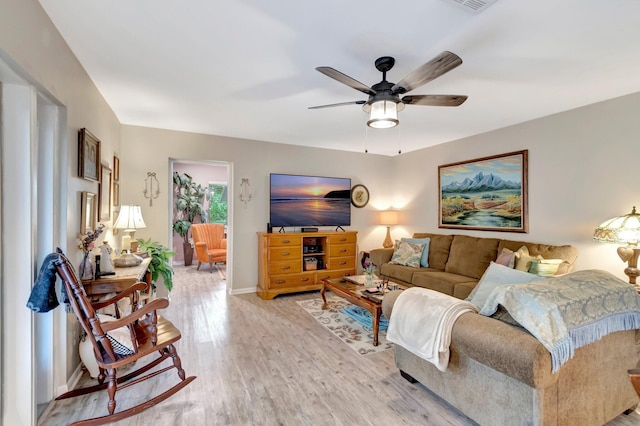 living room with ceiling fan and light wood-type flooring