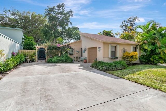 single story home with a front lawn and a garage