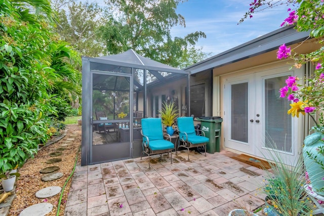 view of patio featuring glass enclosure