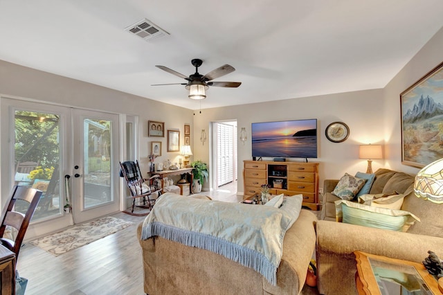 bedroom with french doors, access to outside, ceiling fan, and wood-type flooring