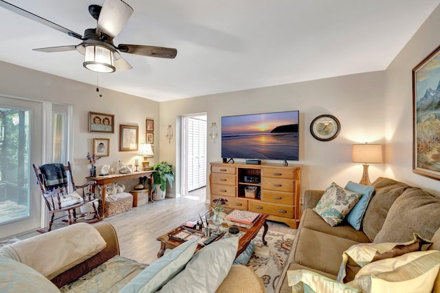 living room featuring light hardwood / wood-style floors, a wealth of natural light, and ceiling fan