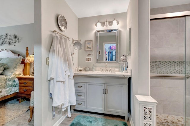 bathroom featuring vanity and tiled shower