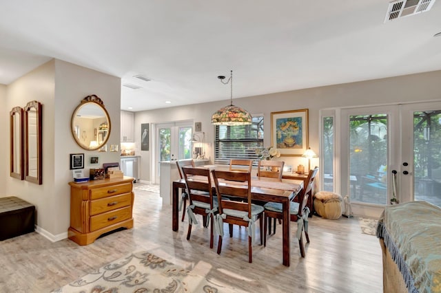 dining area featuring french doors and light hardwood / wood-style flooring