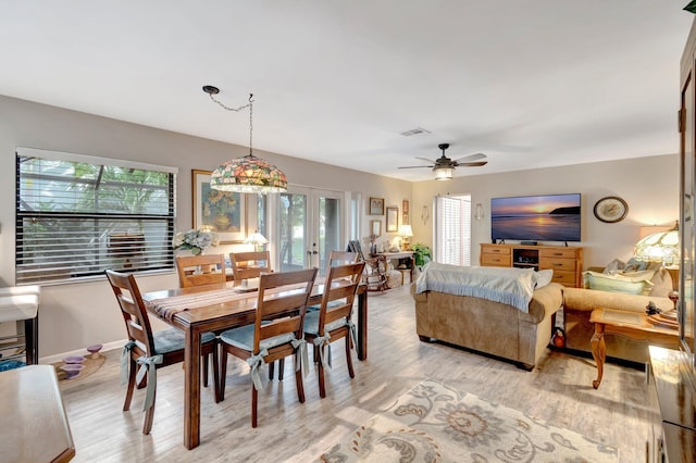 dining room with french doors, light hardwood / wood-style floors, and ceiling fan