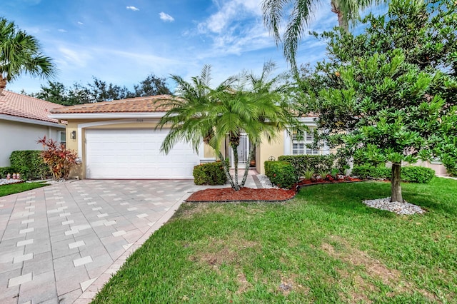 view of front of property with a front yard and a garage