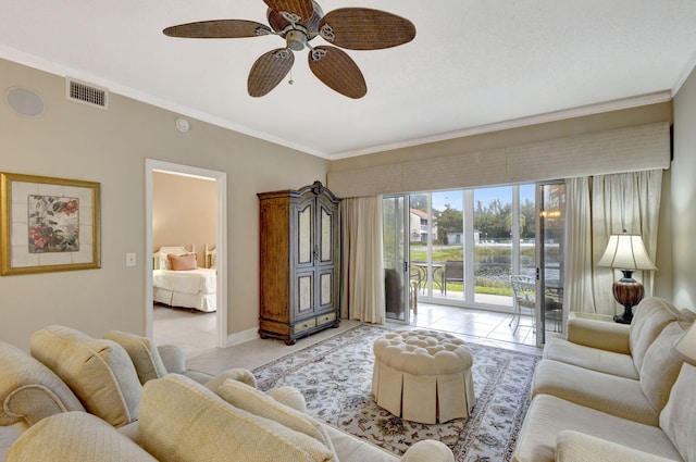 tiled living room with ceiling fan and crown molding