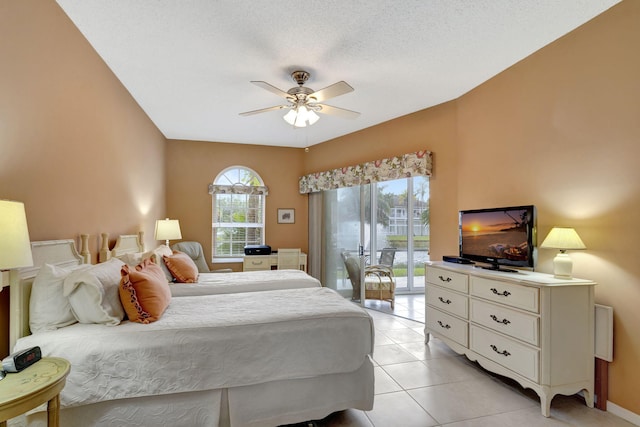 bedroom with a textured ceiling, access to outside, ceiling fan, and light tile patterned flooring