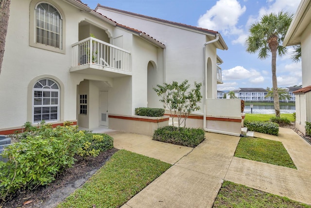 exterior space with a water view and a balcony