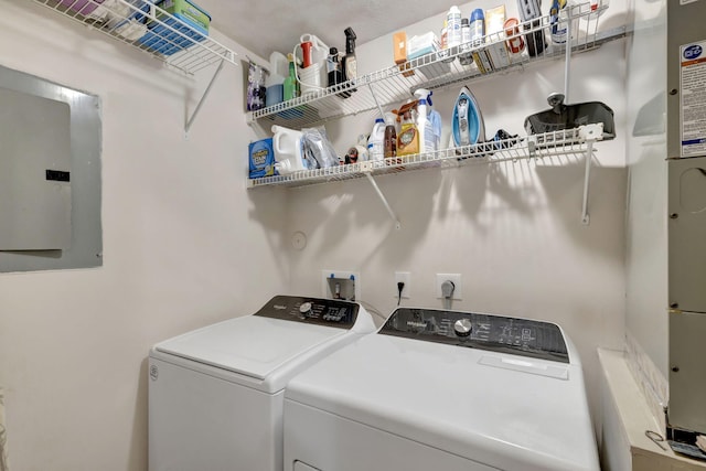 washroom featuring electric panel and washing machine and clothes dryer