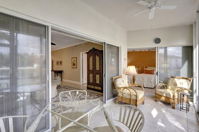 sunroom / solarium featuring ceiling fan