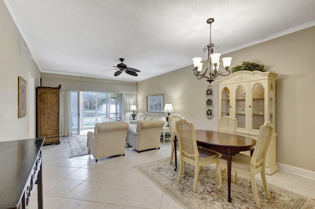 tiled dining room featuring a textured ceiling, ceiling fan with notable chandelier, and ornamental molding