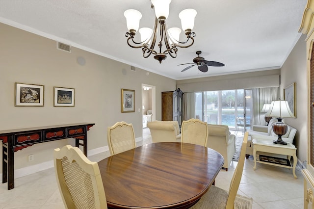 tiled dining room with ceiling fan with notable chandelier and crown molding