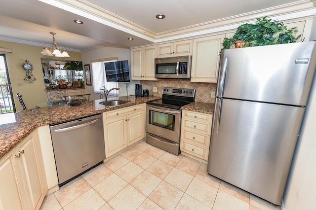 kitchen featuring kitchen peninsula, stainless steel appliances, light stone counters, and tasteful backsplash