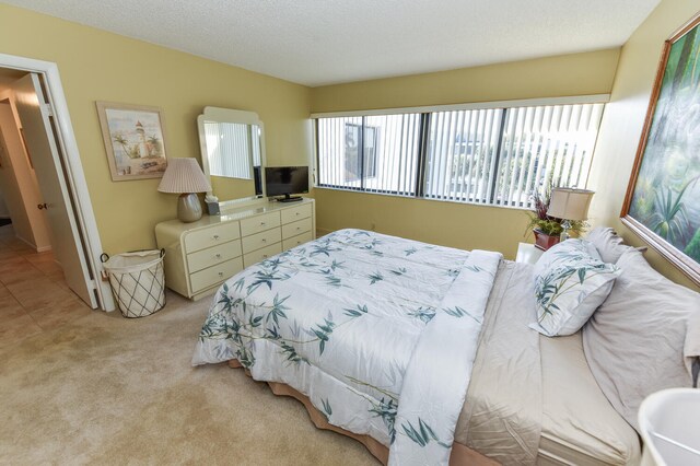 carpeted bedroom with a textured ceiling