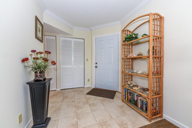 foyer with crown molding and light tile patterned flooring