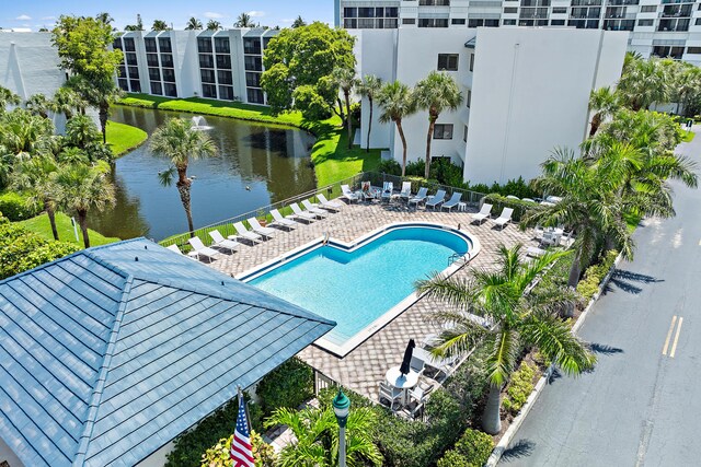 view of pool featuring a patio and a water view