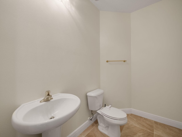 bathroom featuring tile patterned floors, sink, and toilet