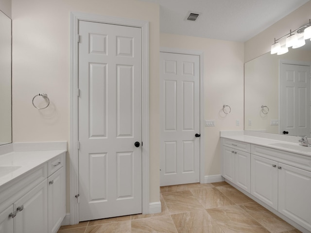 bathroom with tile patterned flooring and vanity